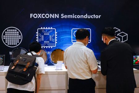 Foxconn shareholders look at wafers on display after the annual